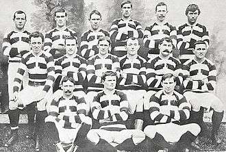 Photo of a group of rugby players posing in their uniforms.