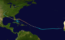 A track begins just west of the tip of Senegal in West Africa: it moves south by west, passing just south of a group of islands called Cape Verde; it curves southwest, then northwest, passing above Puerto Rico and some islands; it curves to the west, crosses the northern edge of some islands called the Bahamas, and then hits a protruding peninsula called Florida; it crosses that peninsula, goes over a body of water called the Gulf of Mexico, and then curves northwest toward land; it hits a bird’s-foot-shaped edge of land called the Mississippi Delta, which is part of a larger land called Louisiana, part of a large continent called North America; it finally moves over land and curves north near the end of the track.