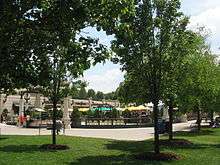 A cafe behind a set of trees and grass