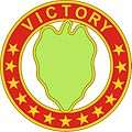 A hollow red circle with stars and the word "Victory", inside a green leaf