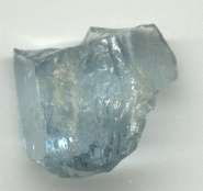 A light blue piece of aquamarine cutting rough.