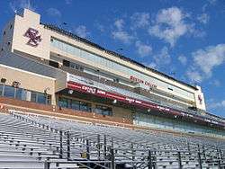 View of the interior of a stadium showing the seats and above them, the press and private boxes.