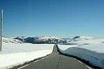 Bare road snow on both sides across a plateau