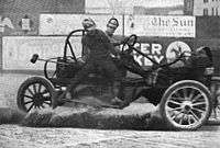 A malletman balances on the side of a moving auto polo car during a match in 1913.