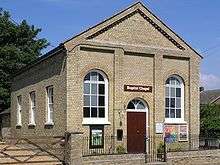 Large oblong brick building with metal railings