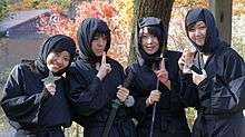 Four young women dressed in black