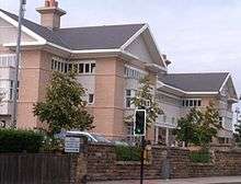 The new Bishop Auckland General facing onto Cockton Hill Road. The picture shows a 3 storey, sandstone clad building, with two large chimneys