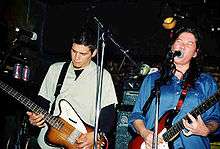 Breeders Mando Lopez and Kim Deal onstage performing a concert