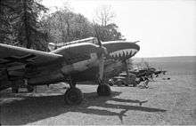 twin engine aircraft with a shark's mouth painted on the nose