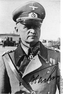 A man wearing a military uniform with an Iron Cross displayed at the front of his uniform collar.