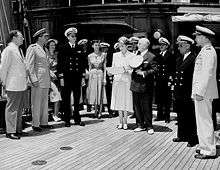 Marjorie Merriweather Post and her husband Ambassador Joseph E. Davies, at center, with Carton Skinner at a presentation of a Naval Reserve Pennant.