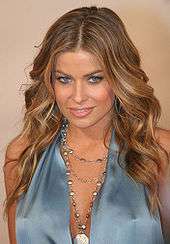 Carmen Electra in low cut blue dress with silver necklace