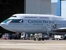 A Cathay Pacific Boeing 747-400 being cleaned at London Heathrow Airport, a South African Airways wingtip can be seen on the left-hand side of the image