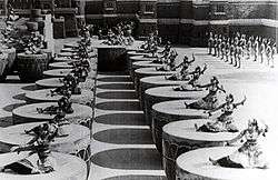 Several women dancing on giant drums.