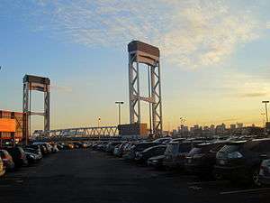 A vertical lift bridge at sunset