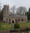 Stone building with square tower.