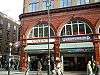 A red-bricked building with a white sign reading "COVENT" in blue letters and a blue sign reading "UNDERGROUND" in white letters under a white sky