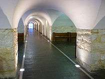 View of the crypt from west to east showing the low curved ceiling and the bays created by the junctions of the arches