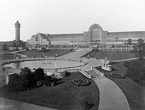 Mono photograph of the front of the Palace and some of its surrounding grounds.