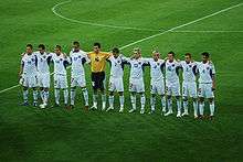 The team standing together before a match.