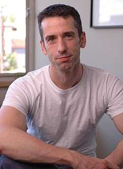 Man facing front wearing white t-shirt