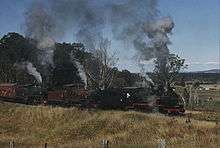 Queensland Rail heritage locos of the PB15, C17 and BB18¼ classes haul a special train for the 125th anniversary of QR on the Little Liverpool Range, west of Grandchester, July 1990.