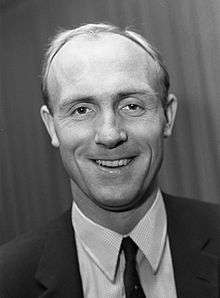 A black-and-white photograph of a smiling Don Howe, who played for Arsenal.