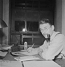 man at desk with pipe