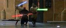 Three men fight with laser swords in an hangar.