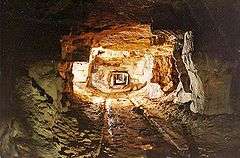 Tunnel between roughly hewn stone walls