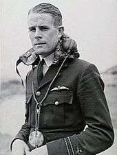 Man in dark uniform with flying helmet