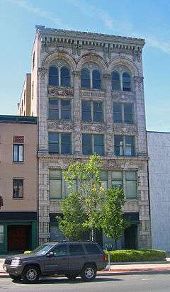 Front view of Foster Building, with car parked in street