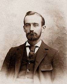 Black and white headshot of Donald Trump's ancestor Frederick Trump, who is wearing a suit and beard