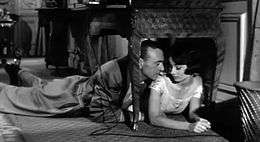 Screen capture of Gary Cooper and Audrey Hepburn lying on the floor