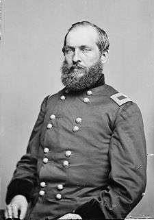 Seated portrait in army uniform. Garfield has a full beard and mustache