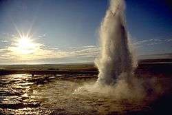 Water erupting into the air from a pool.