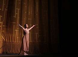 Photograph of Seo with her arms out during the curtain call for Romeo and Juliet on 19 June 2015