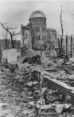 A burned out domed building surrounded by rubble