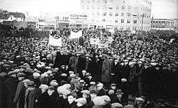 A large group of protesters, some carrying signs