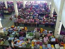 Market, seen from above, with colourful textiles