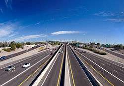 Looking over a highway towards an elevated interchange