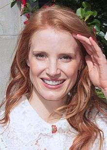 A photograph of Chastain smiling at the 2013 Toronto Film Festival