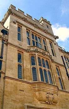 An imposing stone tower with an oriel window below it