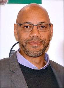 A man wearing a lilac collared shirt.