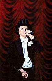 Madonna wearing a tuxedo and hat