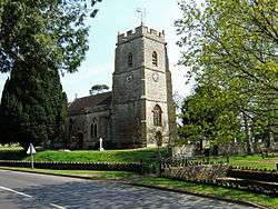 Stone building with square tower.