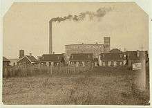 An image capturing the housing conditions for iron mill workers during the industrial era.