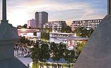 View of outdoor square with pavilions and low-rise and high-rise buildings behind.