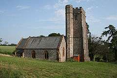 Stone building with sqauer tower.