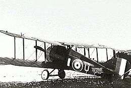 Military biplane parked on landing ground